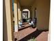 Inviting covered patio with brick flooring, comfortable seating, potted plants, and arched columns at 15149 Canoe Pl, Winter Garden, FL 34787