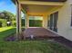 Relaxing covered patio with brick flooring, offering a serene outdoor space with access to the backyard at 15149 Canoe Pl, Winter Garden, FL 34787