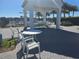 Community patio area offering outdoor seating, a grill, and lake views, perfect for social gatherings at 15149 Canoe Pl, Winter Garden, FL 34787