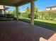 Brick-paved covered patio ideal for outdoor living and enjoying the view of the well-maintained yard at 15149 Canoe Pl, Winter Garden, FL 34787