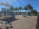 Community playground area featuring a slide, a swing set, and other play equipment with lake views at 15149 Canoe Pl, Winter Garden, FL 34787