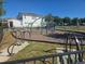 Community playground area featuring climbing structures, exercise equipment, and a soft surface for safety at 15149 Canoe Pl, Winter Garden, FL 34787