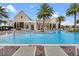 Community splash pool with lounge chairs, palm trees, and a zero entry point at 15149 Canoe Pl, Winter Garden, FL 34787