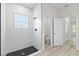 Modern bathroom features a tiled walk-in shower with a window and black hardware at 16745 Sw 29Th Terrace, Ocala, FL 34473