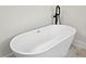 Bright bathroom showcases a modern soaking tub with a matte black faucet fixture at 16745 Sw 29Th Terrace, Ocala, FL 34473