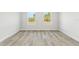 This bedroom features two windows, neutral paint, and wood-look flooring at 16745 Sw 29Th Terrace, Ocala, FL 34473