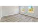 This bedroom has two large windows, white paint, and wood-look floors at 16745 Sw 29Th Terrace, Ocala, FL 34473