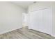 This bedroom features wood-look flooring and a closet with bi-fold doors at 16745 Sw 29Th Terrace, Ocala, FL 34473