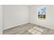 Bright, empty bedroom with hardwood floors and a large window with natural light at 16745 Sw 29Th Terrace, Ocala, FL 34473