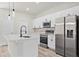 Modern kitchen featuring white cabinets, stainless steel appliances, and a large island at 16745 Sw 29Th Terrace, Ocala, FL 34473