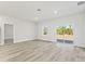 Bright and spacious living room featuring wood floors and a sliding glass door to the backyard at 16745 Sw 29Th Terrace, Ocala, FL 34473
