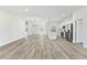 Bright and airy living area with wood-look floors seamlessly connecting living room, dining area, and modern kitchen at 16745 Sw 29Th Terrace, Ocala, FL 34473