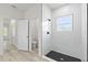 A modern bathroom featuring a walk-in shower with marble tiling and black fixtures and wood-look flooring at 16753 Sw 29Th Terrace, Ocala, FL 34473