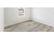 Comfortable bedroom featuring a large window and plank flooring at 16753 Sw 29Th Terrace, Ocala, FL 34473