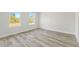 Spacious bedroom with wood-look floors, white walls, and large windows, offering a bright and clean look at 16753 Sw 29Th Terrace, Ocala, FL 34473