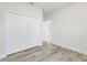 Bedroom with plank floors, closet with folding doors, and an entryway to another room at 16753 Sw 29Th Terrace, Ocala, FL 34473
