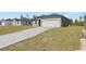 Newly built home with a long concrete driveway leading to an attached two-car garage at 16753 Sw 29Th Terrace, Ocala, FL 34473