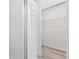 Hallway view of a closet and white walls and wood-look floors at 16753 Sw 29Th Terrace, Ocala, FL 34473