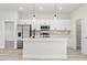 Bright kitchen with stainless steel appliances, white cabinetry, and a large center island with pendant lights at 16753 Sw 29Th Terrace, Ocala, FL 34473