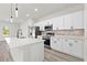 Well-lit kitchen with stainless appliances, white cabinets, subway tile backsplash, and island with pendant lighting at 16753 Sw 29Th Terrace, Ocala, FL 34473