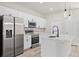 Modern kitchen featuring stainless steel appliances, white cabinets, and a center island with quartz countertops at 16753 Sw 29Th Terrace, Ocala, FL 34473