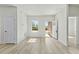 Bright and airy living room featuring wood-look flooring, a window, and an open doorway at 16753 Sw 29Th Terrace, Ocala, FL 34473