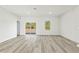 Sun-filled living room with wood-look flooring, sliding glass doors, and ample natural light at 16753 Sw 29Th Terrace, Ocala, FL 34473