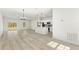 Open-concept living space with wood-look floors, island kitchen, and modern lighting fixtures at 16753 Sw 29Th Terrace, Ocala, FL 34473