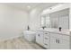 Bright main bathroom featuring a soaking tub, double vanity with modern fixtures, and wood-look floors at 16753 Sw 29Th Terrace, Ocala, FL 34473
