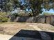 Backyard featuring a wood fence, sparse vegetation, and a partial view of trees at 191 Caldwell St, Apopka, FL 32712