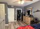 Bedroom with a wood-look floor, standard closet and a dark gray accent wall at 191 Caldwell St, Apopka, FL 32712