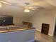 Lofted area with foosball table, TV and wood-look flooring at 191 Caldwell St, Apopka, FL 32712