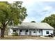 Charming single-story home featuring a welcoming front porch and mature trees providing ample shade at 191 Caldwell St, Apopka, FL 32712