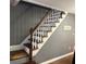 Classic staircase with white railings and stained wood treads at 191 Caldwell St, Apopka, FL 32712