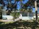 Cozy backyard with patio, mature trees, and ample green space for outdoor enjoyment at 1933 Bayview Dr, New Smyrna Beach, FL 32168