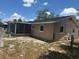 View of the house exterior showing the backyard with a screened porch at 2108 Wolf Rd, Orlando, FL 32808
