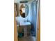 Bathroom with a pedestal sink, toilet, and shower with curtain at 2108 Wolf Rd, Orlando, FL 32808