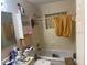 Bathroom showing the bathtub, toilet, sink and a decorative mirror at 2108 Wolf Rd, Orlando, FL 32808