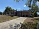 Charming single-story home with a long driveway and attached garage at 2108 Wolf Rd, Orlando, FL 32808