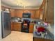 A full kitchen with stainless steel appliances and tile floors at 2108 Wolf Rd, Orlando, FL 32808