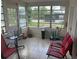 Sunroom with tiled floor, windows, table, and chairs at 2108 Wolf Rd, Orlando, FL 32808