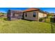 Beautiful backyard featuring lush green grass, a screened in patio, and a metal fence at 212 Lugano Way, Debary, FL 32713