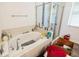 Bright bathroom featuring a soaking tub, glass-enclosed shower, and tiled walls at 212 Lugano Way, Debary, FL 32713