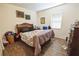 Comfortable bedroom with wood-look tile flooring, decor, and natural light from a window at 212 Lugano Way, Debary, FL 32713
