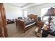 Bright bedroom with wood-look tile flooring, natural light, and a large bed at 212 Lugano Way, Debary, FL 32713
