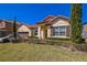 Charming one-story home featuring a red tile roof, lush landscaping, and a well-maintained front yard at 212 Lugano Way, Debary, FL 32713