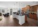 Bright kitchen with large island, stainless appliances, dark countertops, and stylish cabinetry at 212 Lugano Way, Debary, FL 32713