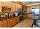 Well-equipped kitchen featuring stainless steel appliances, granite countertops, and wooden cabinets at 212 Lugano Way, Debary, FL 32713