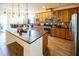 Open kitchen with a large island, granite countertops, and stainless steel appliances, perfect for entertaining at 212 Lugano Way, Debary, FL 32713