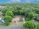Aerial view of home with large lot, detached garage, and basketball court surrounded by lush greenery at 225 N Phippen Ave, Deland, FL 32724